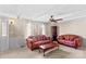 Living room featuring two red sofas, coffee table, and ceiling fan at 906 Harmony Dr, Statesville, NC 28677