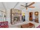 Living room showcasing a stone fireplace and a grandfather clock at 906 Harmony Dr, Statesville, NC 28677
