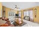 Living area with leather sofa, coffee table, and large windows at 906 Harmony Dr, Statesville, NC 28677