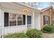 Cozy front porch featuring a blue front door with white trim and a well-kept lawn with green bushes at 1109 Cherry Meadow Ln, Rock Hill, SC 29732