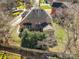 Bird's eye view of the property displaying the brick home, back patio and partial tree coverage at 11402 Bloomfield Dr, Charlotte, NC 28277