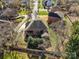 An aerial view displays the backyard of a brick home, including the fence line and surrounding neighborhood at 11402 Bloomfield Dr, Charlotte, NC 28277