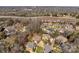 A higher aerial view of a suburban neighborhood adjacent to a highway and wooded area at 11402 Bloomfield Dr, Charlotte, NC 28277