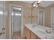 Bathroom with large mirror, double sink and tub with shower at 11402 Bloomfield Dr, Charlotte, NC 28277