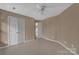 Neutral bedroom with light beige walls, carpeted floors, and a ceiling fan at 11402 Bloomfield Dr, Charlotte, NC 28277