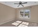 The bedroom features a window, ceiling fan, and carpeted floors at 11402 Bloomfield Dr, Charlotte, NC 28277