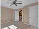This bedroom offers carpeted floors, a ceiling fan, and lots of natural light at 11402 Bloomfield Dr, Charlotte, NC 28277