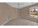 Bedroom with neutral carpet, ceiling fan and view from large window at 11402 Bloomfield Dr, Charlotte, NC 28277