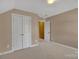 Neutral bedroom with closet and view into another room at 11402 Bloomfield Dr, Charlotte, NC 28277