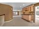 Open bonus room with wet bar, neutral carpet, and great natural light at 11402 Bloomfield Dr, Charlotte, NC 28277