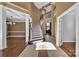 Grand foyer features an open staircase, travertine floors, and abundant natural light, creating a welcoming entrance at 11402 Bloomfield Dr, Charlotte, NC 28277