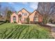 Traditional brick home featuring a manicured lawn and tasteful landscaping in a suburban setting at 11402 Bloomfield Dr, Charlotte, NC 28277