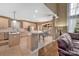 Eat-in kitchen featuring granite countertops, tiled floors, an island, and plenty of natural light from a large window at 11402 Bloomfield Dr, Charlotte, NC 28277