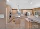 Bright kitchen boasts an island with gas cooktop, stainless appliances, and ample counter space for meal preparation at 11402 Bloomfield Dr, Charlotte, NC 28277