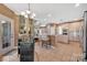 The kitchen features a breakfast bar, tile floors, modern appliances, and chandelier lighting at 11402 Bloomfield Dr, Charlotte, NC 28277