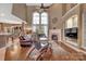 Inviting living room with high ceilings, large windows, a cozy fireplace, and hardwood floors throughout at 11402 Bloomfield Dr, Charlotte, NC 28277