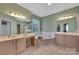 The main bathroom features a soaking tub, dual vanities, and marble floors at 11402 Bloomfield Dr, Charlotte, NC 28277