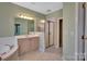 This bathroom features a soaking tub, a stand up shower, and tile flooring at 11402 Bloomfield Dr, Charlotte, NC 28277