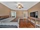 This main bedroom boasts hardwood floors, a ceiling fan, and access to the bathroom at 11402 Bloomfield Dr, Charlotte, NC 28277