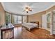 The spacious main bedroom features hardwood floors, bay windows, and a ceiling fan at 11402 Bloomfield Dr, Charlotte, NC 28277