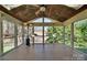 This screened porch offers a wood plank floor, fan, heater, and lots of light at 11402 Bloomfield Dr, Charlotte, NC 28277