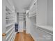 This walk-in closet features hardwood floors and custom shelving at 11402 Bloomfield Dr, Charlotte, NC 28277