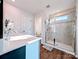 Bathroom featuring a glass shower, modern fixtures, and a vanity with ample storage at 12712 Wandering Brook Dr, Charlotte, NC 28273