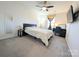 This spacious bedroom features a ceiling fan, TV, and a desk near the window at 12712 Wandering Brook Dr, Charlotte, NC 28273