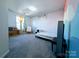 Bright bedroom with gray carpet, colorful murals, and a sunny window with yellow curtains at 12712 Wandering Brook Dr, Charlotte, NC 28273