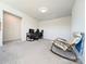 Spacious bonus room with neutral carpet, desk, and comfortable rocking chair, perfect for relaxing or working from home at 12712 Wandering Brook Dr, Charlotte, NC 28273