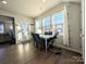 Bright dining area with large windows and modern table set at 12712 Wandering Brook Dr, Charlotte, NC 28273
