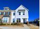 Low angle, exterior elevation of a modern two-story townhome under a bright blue sky at 12712 Wandering Brook Dr, Charlotte, NC 28273