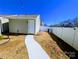 Detached single-car garage with a white door and matching white privacy fence at 12712 Wandering Brook Dr, Charlotte, NC 28273
