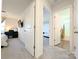 Hallway view highlighting bedroom and bathroom entrances, creating a sense of flow and accessibility within the home at 12712 Wandering Brook Dr, Charlotte, NC 28273