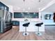 Modern kitchen showcases a center island, stainless steel appliances, and sleek dark blue cabinets at 12712 Wandering Brook Dr, Charlotte, NC 28273