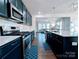 Well-equipped kitchen with stainless steel appliances, white countertops, and dark cabinetry at 12712 Wandering Brook Dr, Charlotte, NC 28273