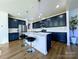 Beautiful kitchen features a center island, stainless steel appliances, and dark blue cabinets at 12712 Wandering Brook Dr, Charlotte, NC 28273