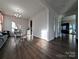 Open-concept living area with hardwood floors and abundant natural light from the large windows at 12712 Wandering Brook Dr, Charlotte, NC 28273