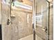 Tiled shower with built-in niche and bench, complemented by a rainfall shower head and glass enclosure at 12712 Wandering Brook Dr, Charlotte, NC 28273