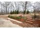 Backyard with greenery and a brick patio at 128 Summerlea Dr, Charlotte, NC 28214