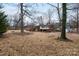 Expansive backyard view featuring trees, and a house with a back deck at 128 Summerlea Dr, Charlotte, NC 28214