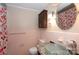 Stylish pink-tiled bathroom with a glass vessel sink and modern fixtures at 128 Summerlea Dr, Charlotte, NC 28214