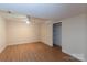 Spacious bedroom featuring a ceiling fan, hardwood floors, and a closet at 128 Summerlea Dr, Charlotte, NC 28214