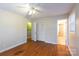 Bright bedroom boasts wood floors, neutral walls, and a ceiling fan at 128 Summerlea Dr, Charlotte, NC 28214