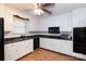Traditional-style kitchen features white cabinets, dark countertops, and modern appliances at 128 Summerlea Dr, Charlotte, NC 28214