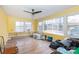 Living room with yellow walls and multiple windows at 128 Summerlea Dr, Charlotte, NC 28214