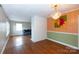 Open-concept living space with hardwood floors, a brick column, and a chandelier at 128 Summerlea Dr, Charlotte, NC 28214