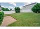 Lush green backyard with a well-maintained lawn and a sturdy white fence for privacy at 13410 Tartarian Ct, Charlotte, NC 28215
