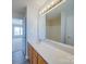 Bathroom with long vanity, a large mirror and view of the bedroom at 13410 Tartarian Ct, Charlotte, NC 28215