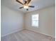 Bedroom with soft carpet, natural light from the window and a modern ceiling fan at 13410 Tartarian Ct, Charlotte, NC 28215